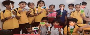 A group of children showcasing their colorful paper crafts.